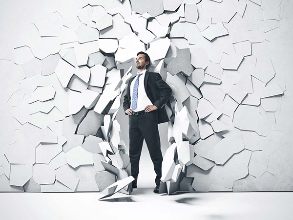 Man standing in front of broken wall