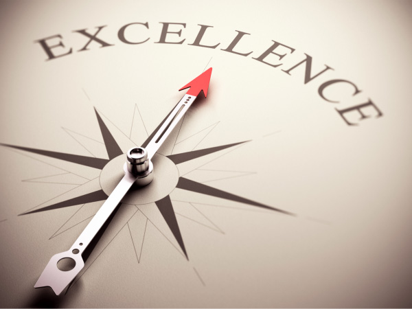 Compass pointed towards the word excellence