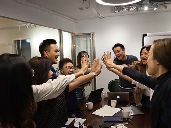 Team Growth Group of people raised hands high fiving