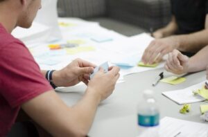 Folding sticky notes during a team meeting