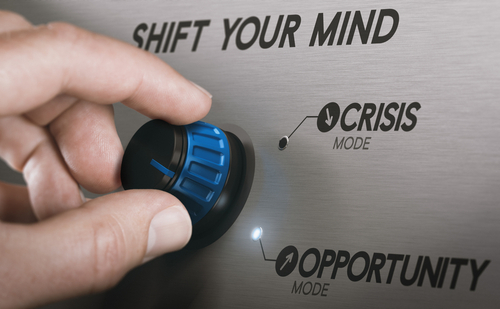 Man Turning A Knob From Crisis To Opportunity